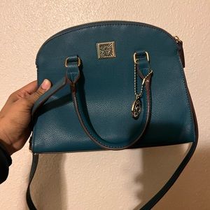 New, only used once. Bluebird turquoise hand bag with shoulder straps